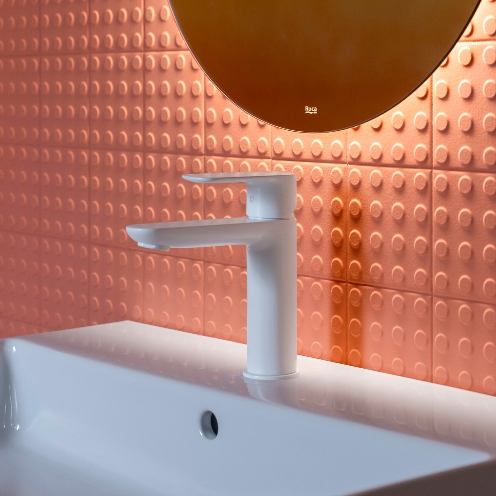 Lifestyle image of the Roca Cala Matt White Basin Mixer Tap on a white basin